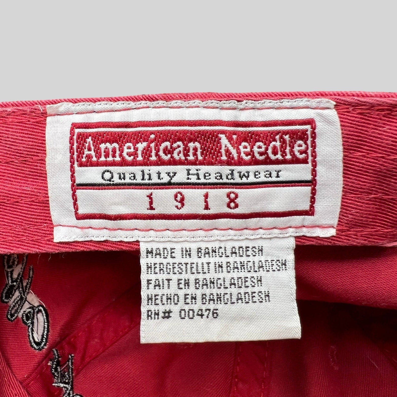 Raree Finds American Needle interior brand label and care tag inside a red cotton Starbucks strapback hat