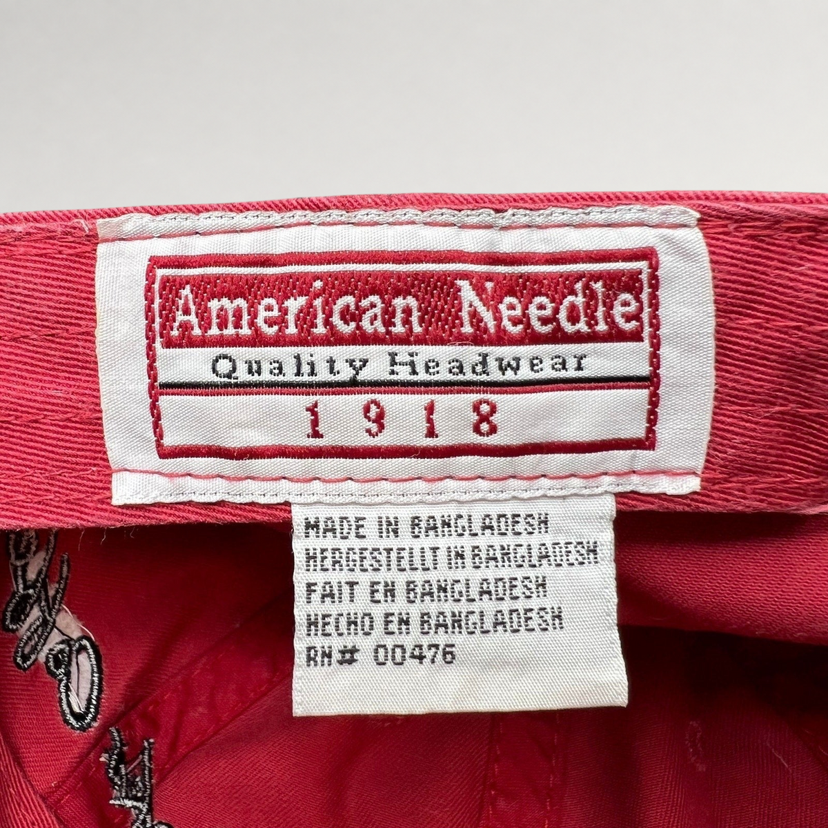 Raree Finds American Needle interior brand label and care tag inside a red cotton Starbucks strapback hat