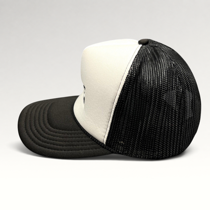 Raree Finds vintage AMP Any Means Possible trucker hat with white foam front, black mesh back, and curved brim.