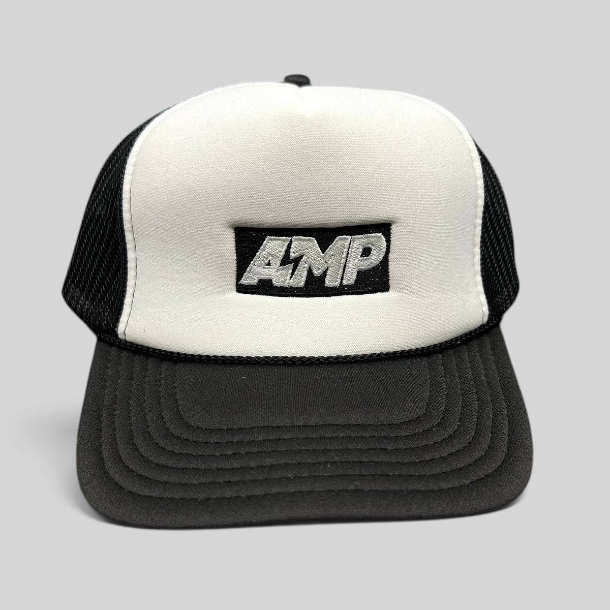 Raree Finds vintage AMP trucker hat with white foam front, black mesh back, and embroidered logo on a curved brim.