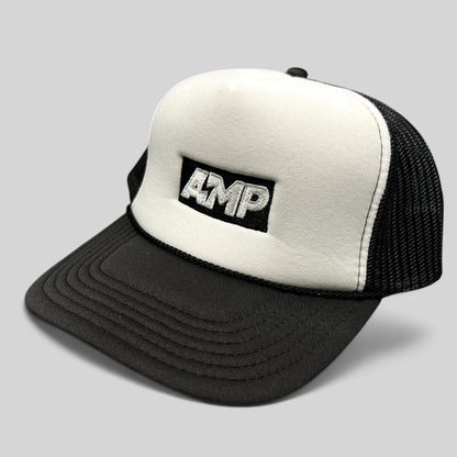 Raree Finds vintage AMP Any Means Possible trucker hat with white foam front, black mesh back, and embroidered logo.