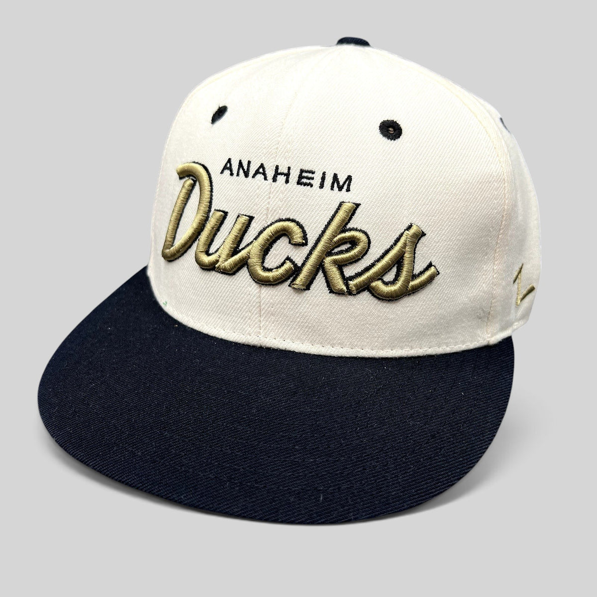 Raree Finds Anaheim Ducks Zephyr snapback hat with white crown, black brim, and gold raised script embroidery.
