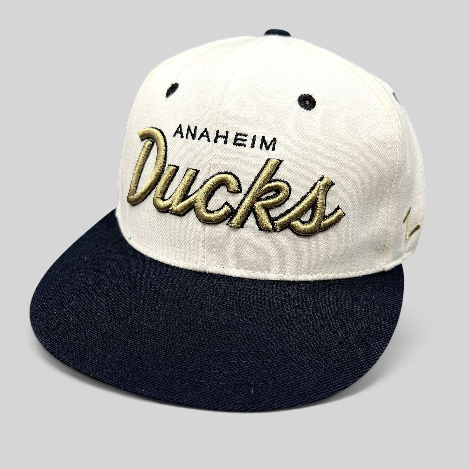 Raree Finds Anaheim Ducks Zephyr snapback hat with white crown, black brim, and gold raised script embroidery.