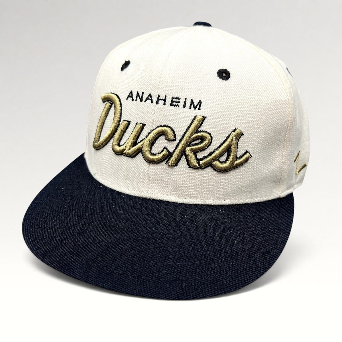 Raree Finds Anaheim Ducks Zephyr snapback hat with white crown, black brim, and gold raised script embroidery.