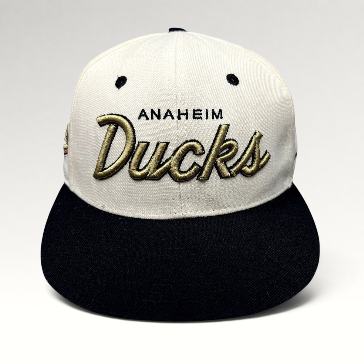 Raree Finds Anaheim Ducks Zephyr snapback hat with white crown, black brim, and raised gold script embroidery.