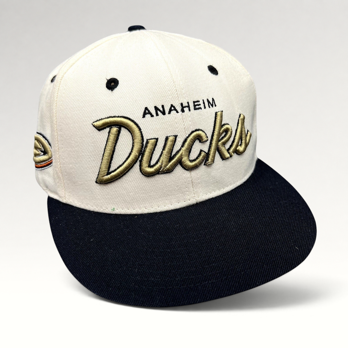Raree Finds Anaheim Ducks Zephyr snapback hat with white crown, black brim, and gold raised script embroidery.