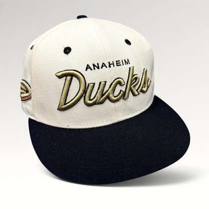 Raree Finds Anaheim Ducks Zephyr snapback hat with white crown, black brim, and gold raised script embroidery.