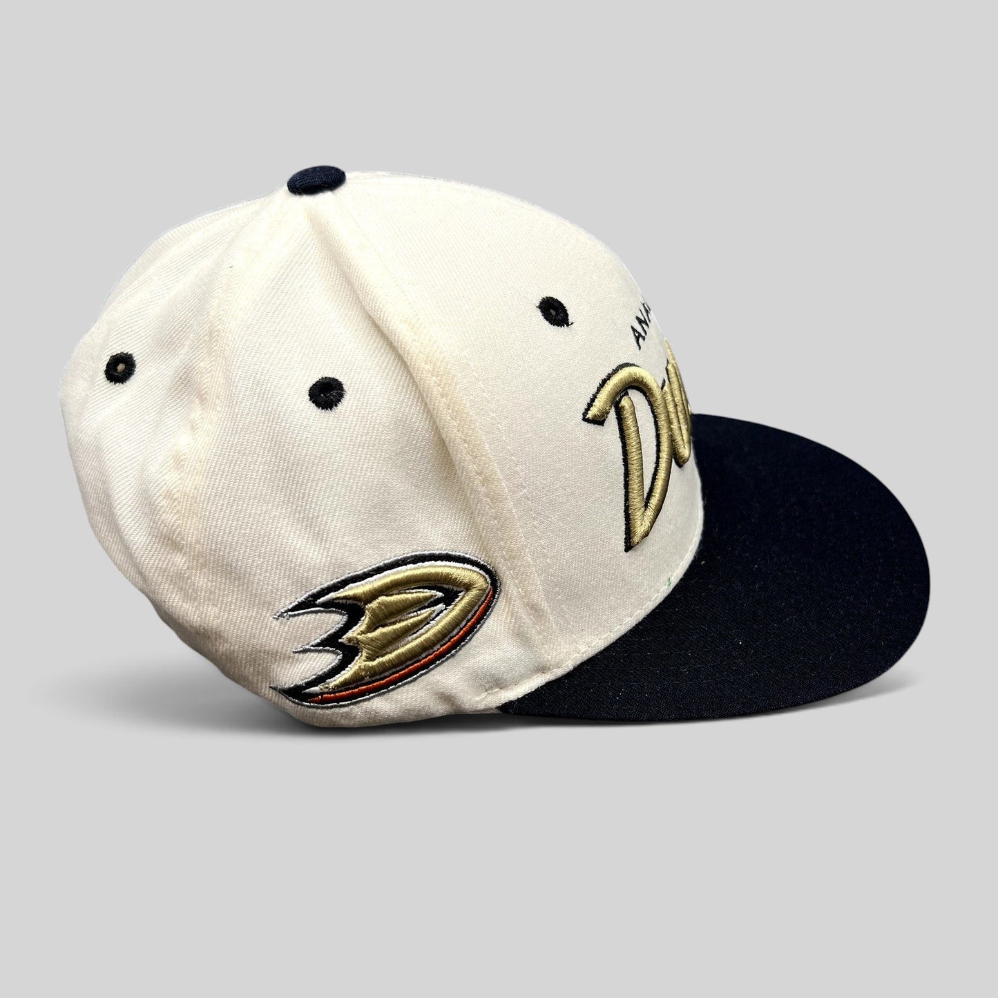 Raree Finds Anaheim Ducks Zephyr snapback hat with white crown, black brim, and gold script embroidery.