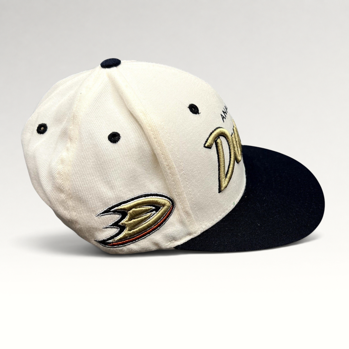 Raree Finds Anaheim Ducks Zephyr snapback hat with white crown, black brim, and gold script embroidery.