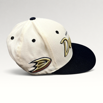 Raree Finds Anaheim Ducks Zephyr snapback hat with white crown, black brim, and gold script embroidery.