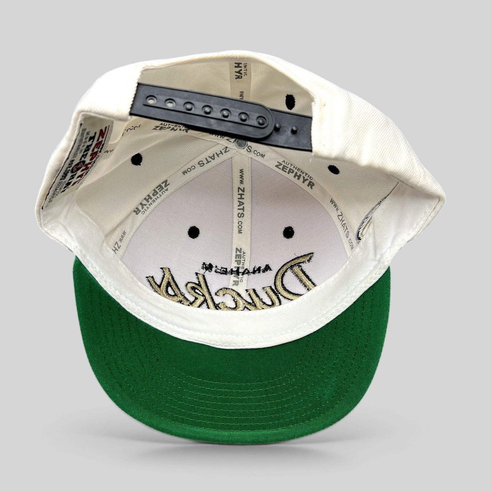 Raree Finds Anaheim Ducks Zephyr snapback hat interior view showing green undervisor and branded interior taping