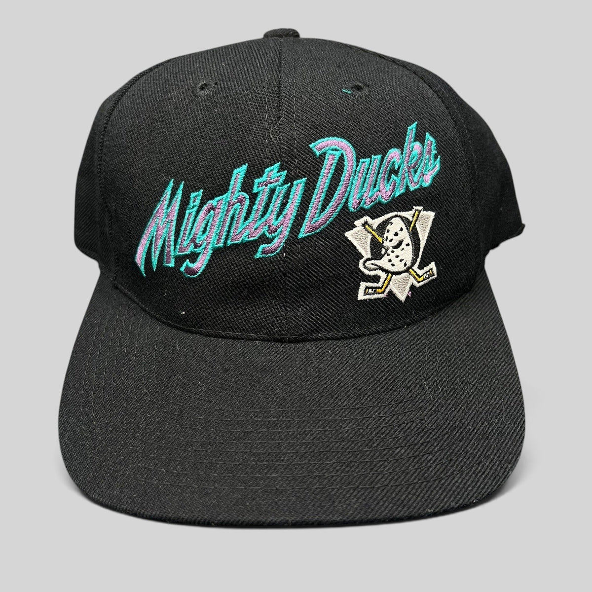 Raree Finds vintage Anaheim Mighty Ducks snapback hat in black with teal and purple script logo and Wild Wing emblem.