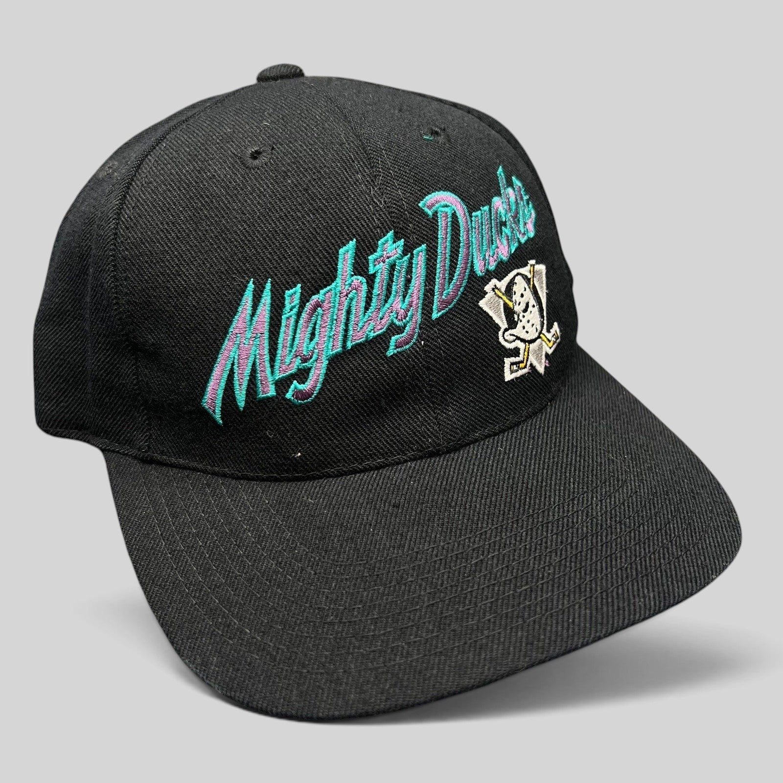 Raree Finds vintage Anaheim Mighty Ducks snapback hat in black with teal and purple script logo and Wild Wing emblem.