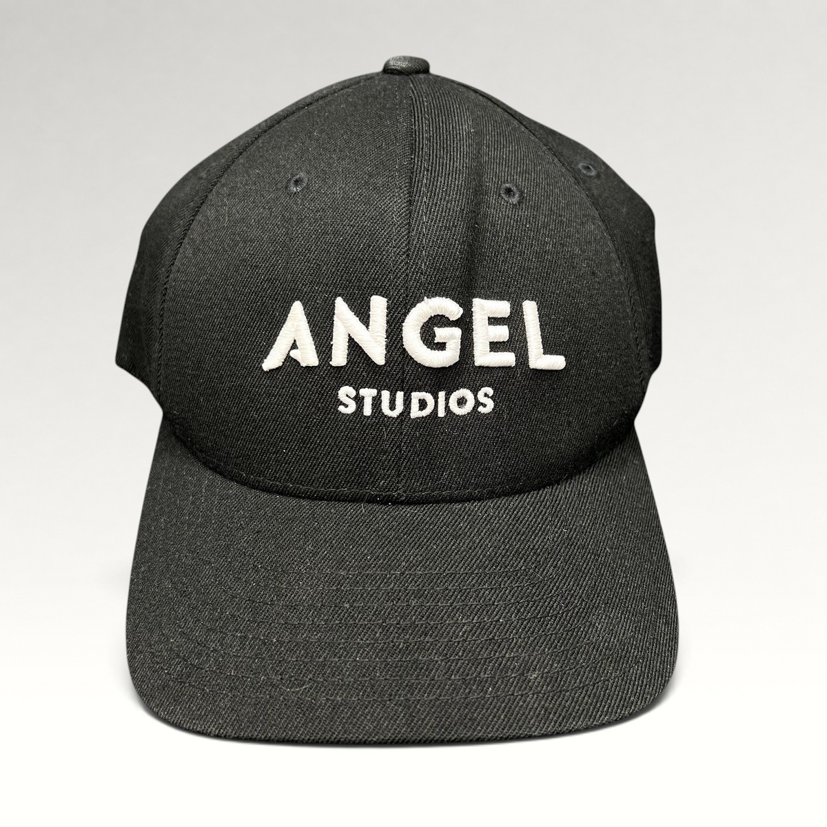 Raree Finds black Flexfit cap with white embroidered Angel Studios logo and structured curved brim