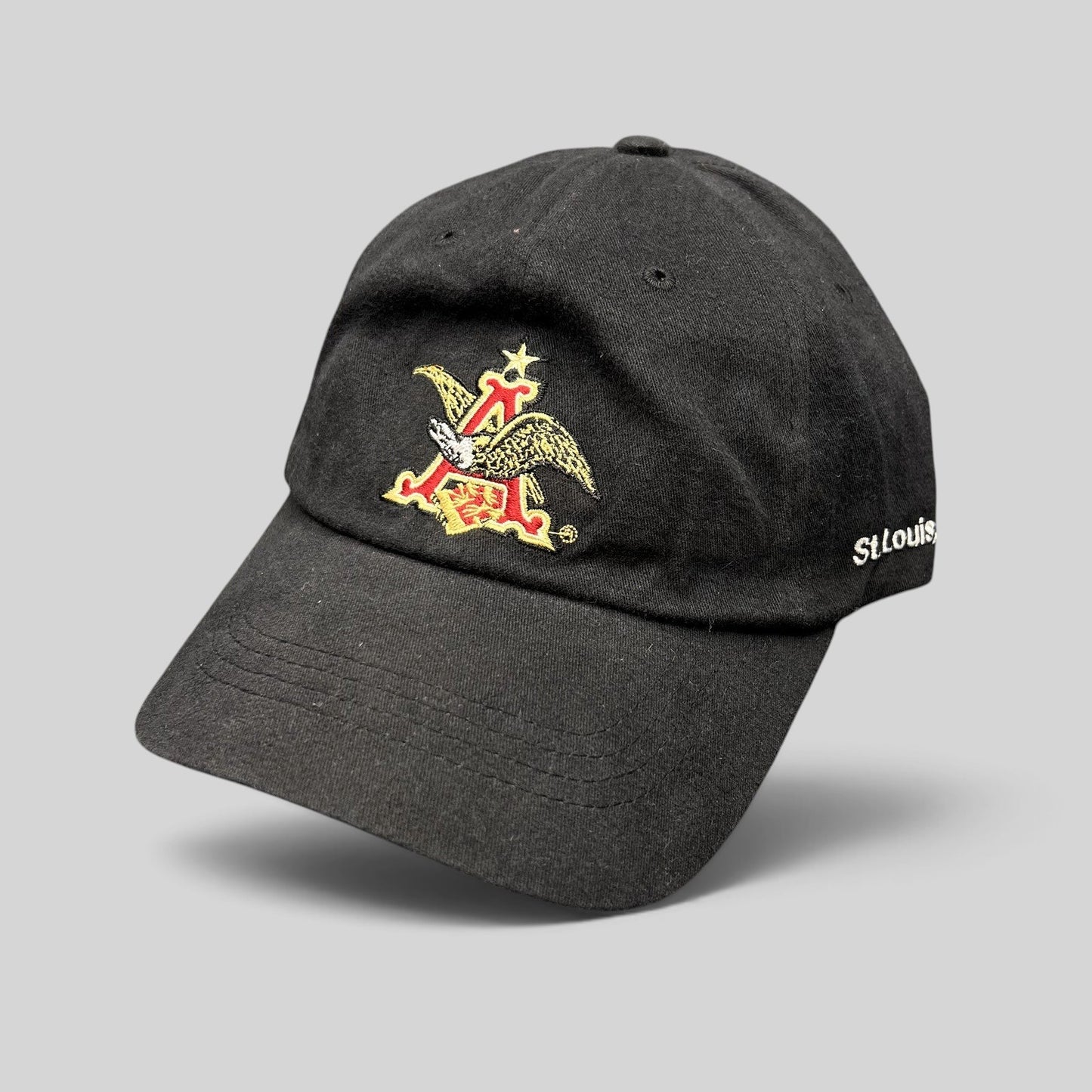 Raree Finds black cotton dad cap featuring an embroidered Anheuser-Busch A and Eagle logo and St. Louis side detail.