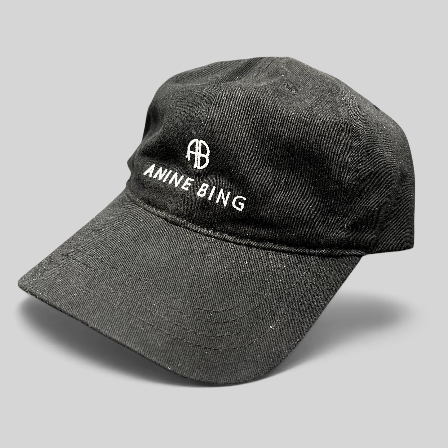 Raree Finds black cotton Anine Bing Sport dad cap with white embroidered AB monogram and logo on the front.