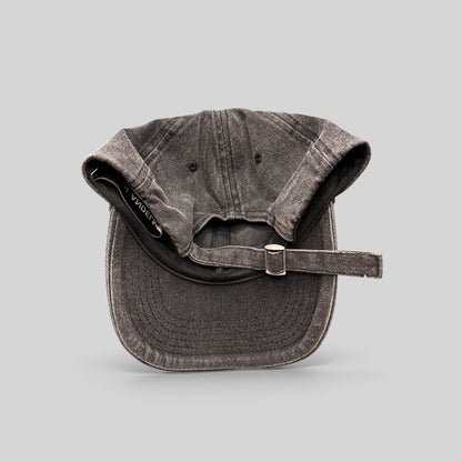 Raree Finds Ann Andelman washed black denim baseball cap with adjustable metal slide buckle and distressed brim detail.