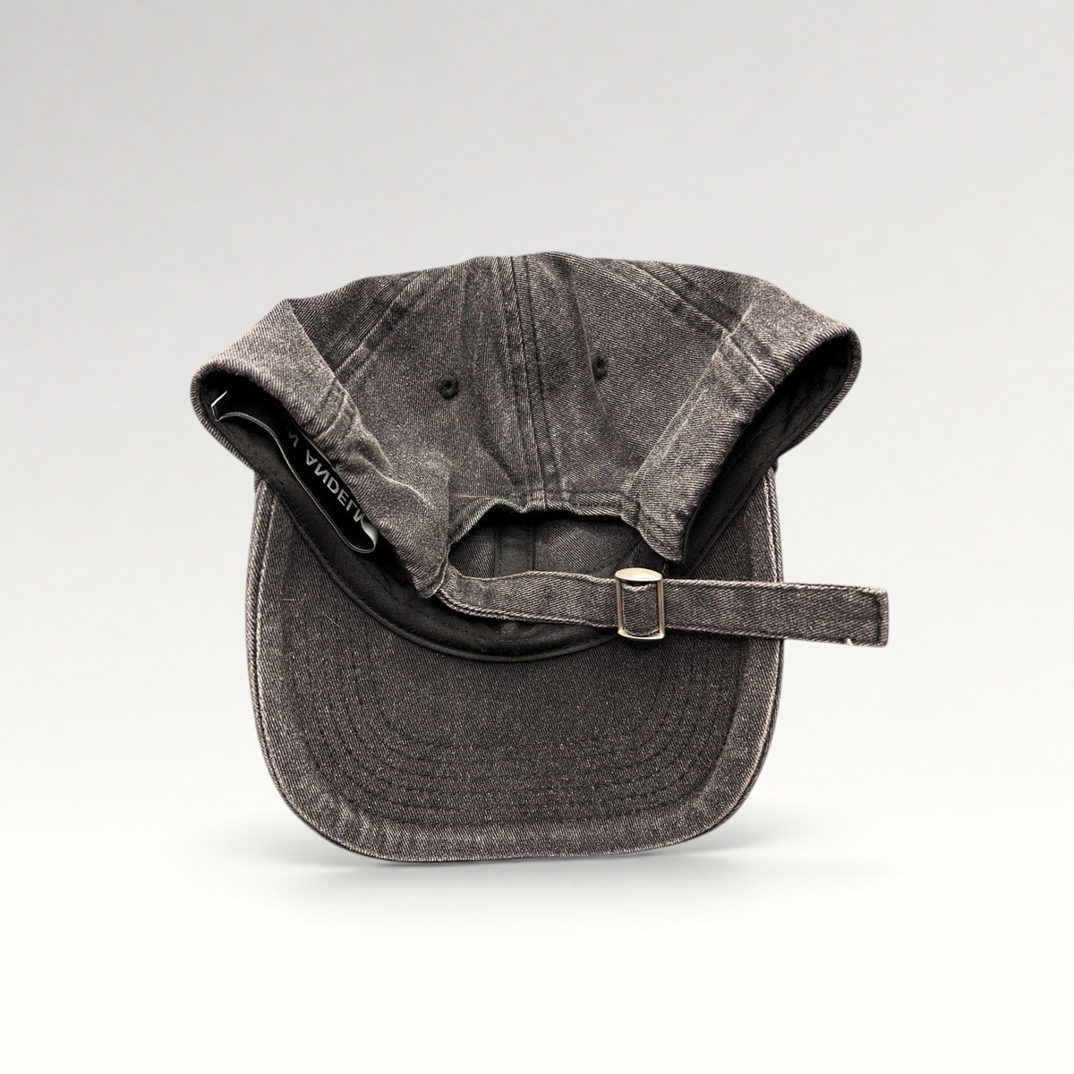 Raree Finds Ann Andelman washed black denim baseball cap with adjustable metal slide buckle and distressed brim detail.