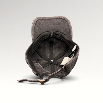 Raree Finds Ann Andelman black denim baseball cap, showing the interior, adjustable strap, and distressed brim.