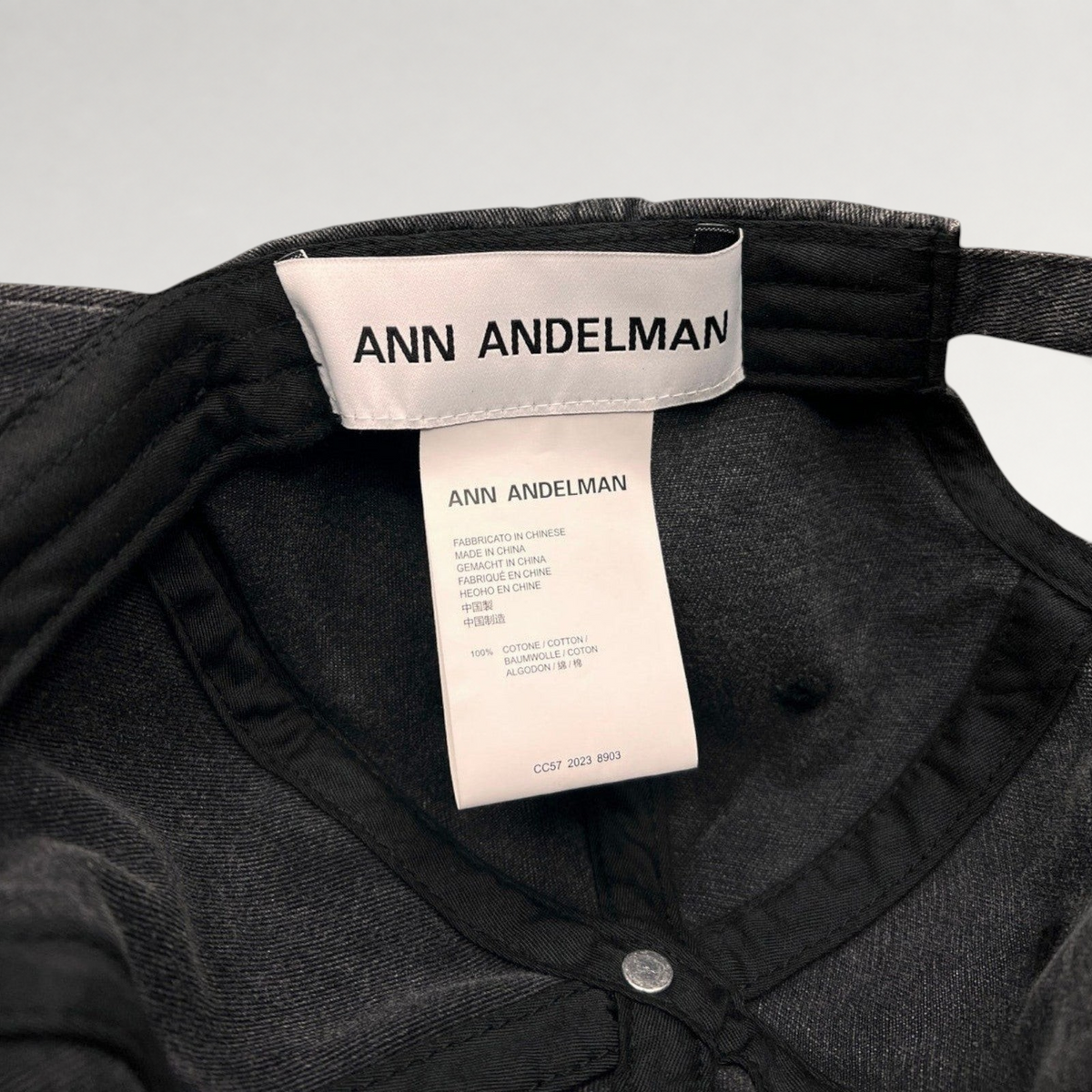 Raree Finds Ann Andelman black denim baseball cap interior showing brand label and 100% cotton care tag
