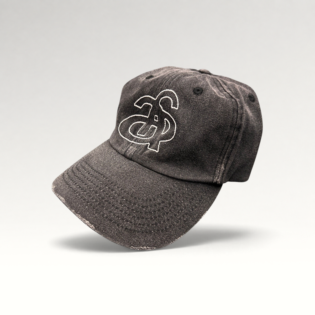 Raree Finds Ann Andelman black denim baseball cap with white embroidered monogram logo and distressed brim detail.