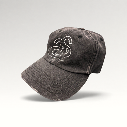 Raree Finds Ann Andelman black denim baseball cap with white embroidered monogram logo and distressed brim detail.