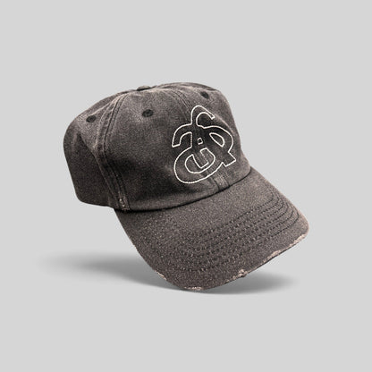 Raree Finds Ann Andelman black denim baseball cap with white embroidered monogram logo and distressed brim detail.