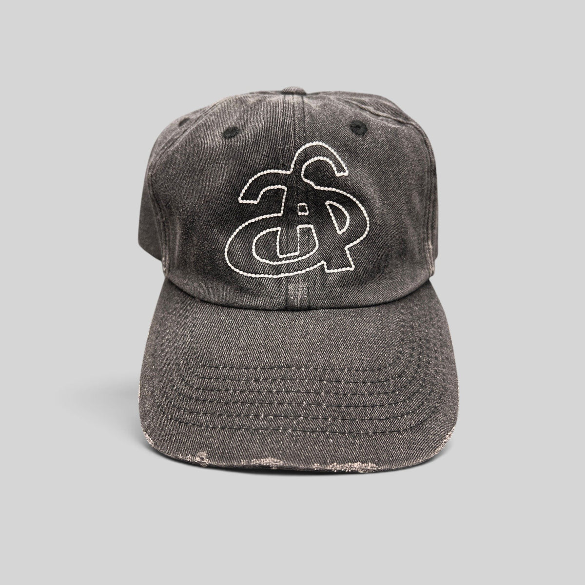 Raree Finds Ann Andelman distressed black denim baseball cap with white embroidered monogram logo on front