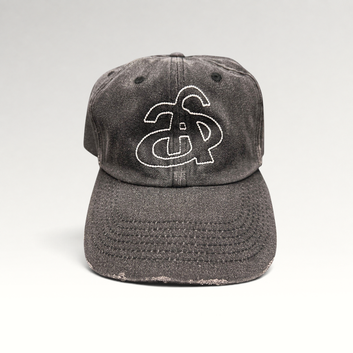 Raree Finds Ann Andelman distressed black denim baseball cap with white embroidered monogram logo on front