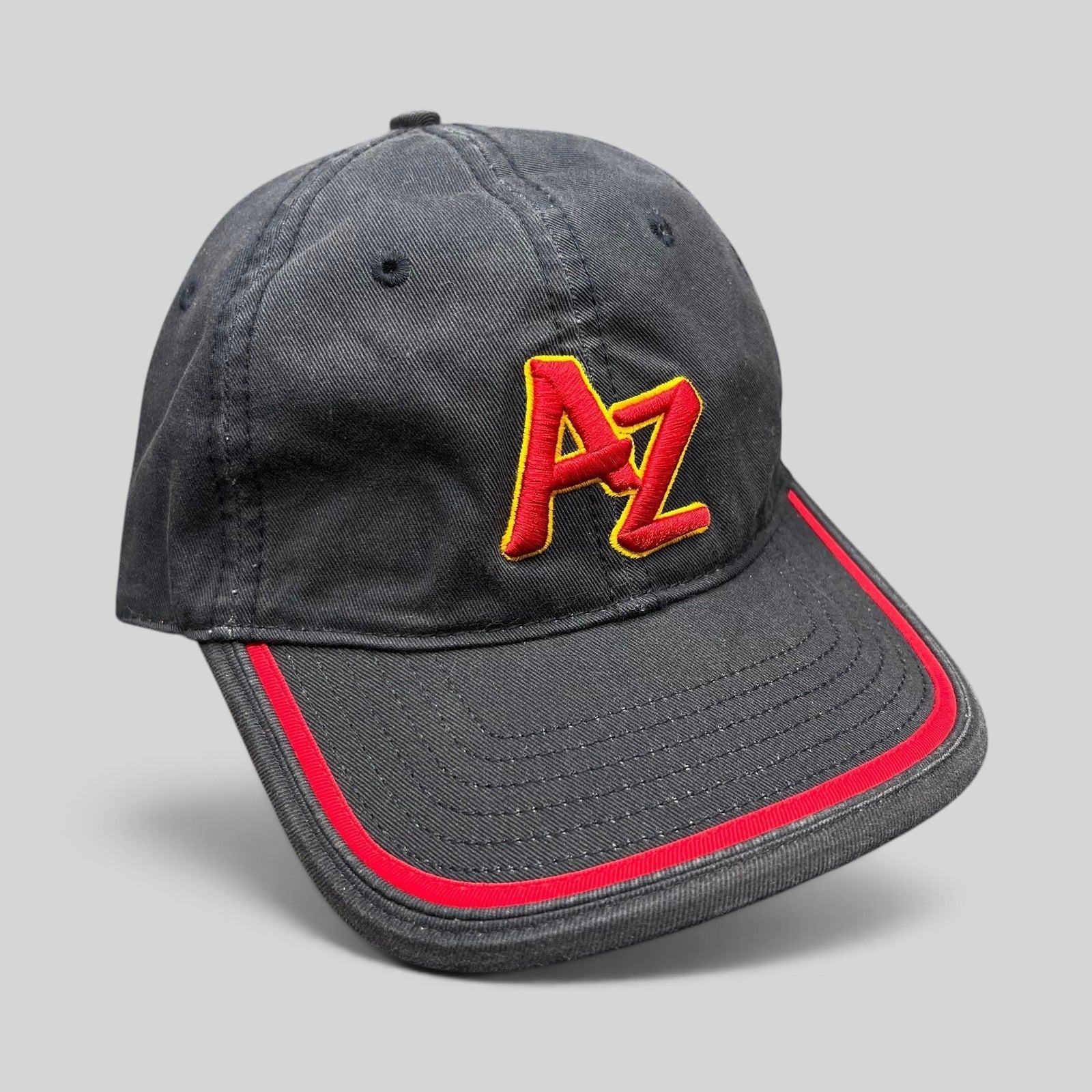 Raree Finds Arizona Iced Tea black strapback hat with raised red and yellow AZ logo embroidery and red brim piping.