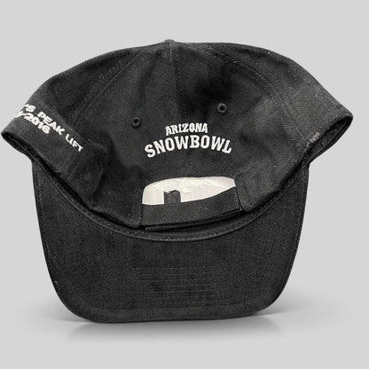 Raree Finds black Yupoong strapback hat featuring Arizona Snowbowl embroidery on the back and Humphreys Peak text.