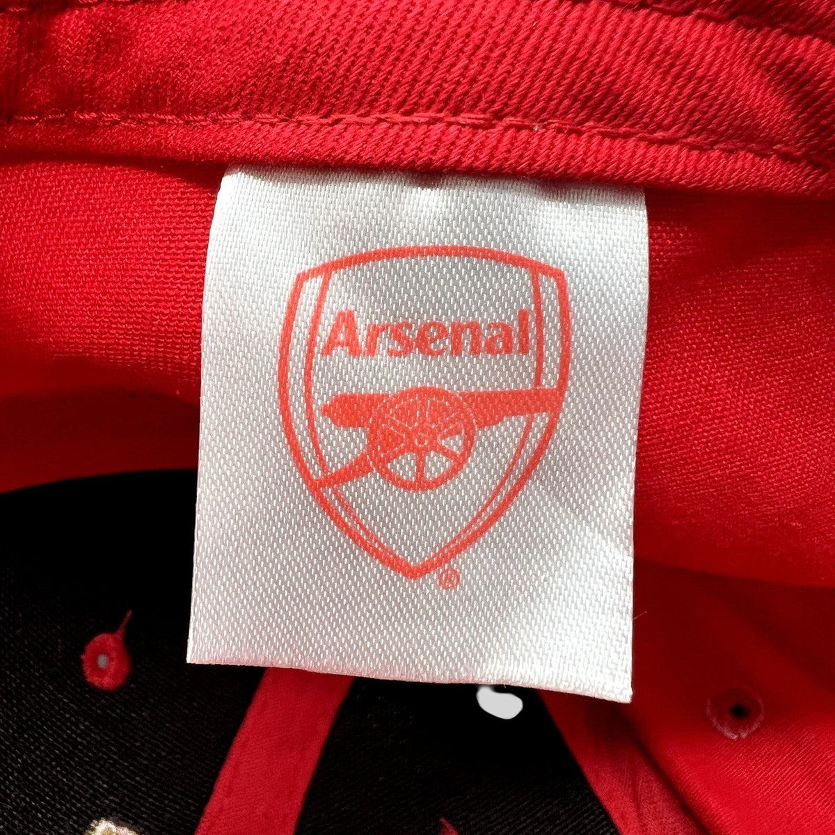 Raree Finds Arsenal FC red strapback hat interior label with embroidered cannon crest logo on white fabric tag