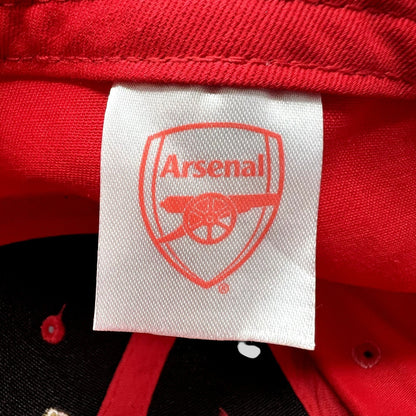 Raree Finds Arsenal FC red strapback hat interior label with embroidered cannon crest logo on white fabric tag