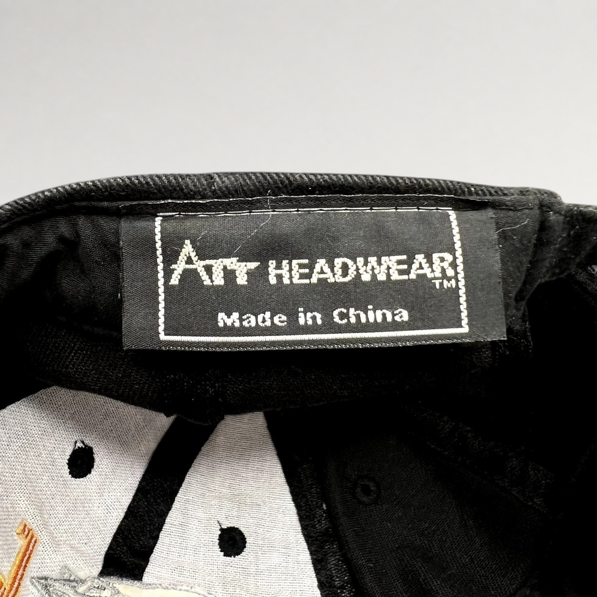 Raree Finds black cotton cap interior showing the Art Headwear brand label and Made in China tag