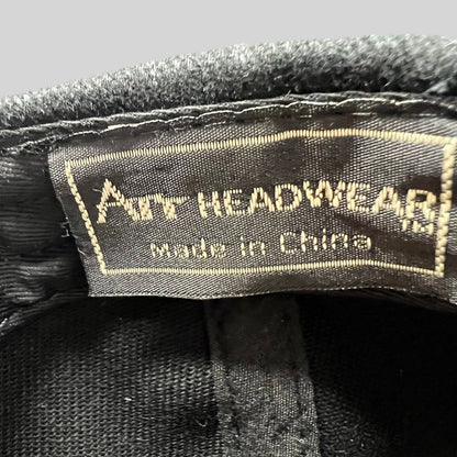 Raree Finds black cap interior label showing Art Headwear branding and made in China text on a fabric tag.