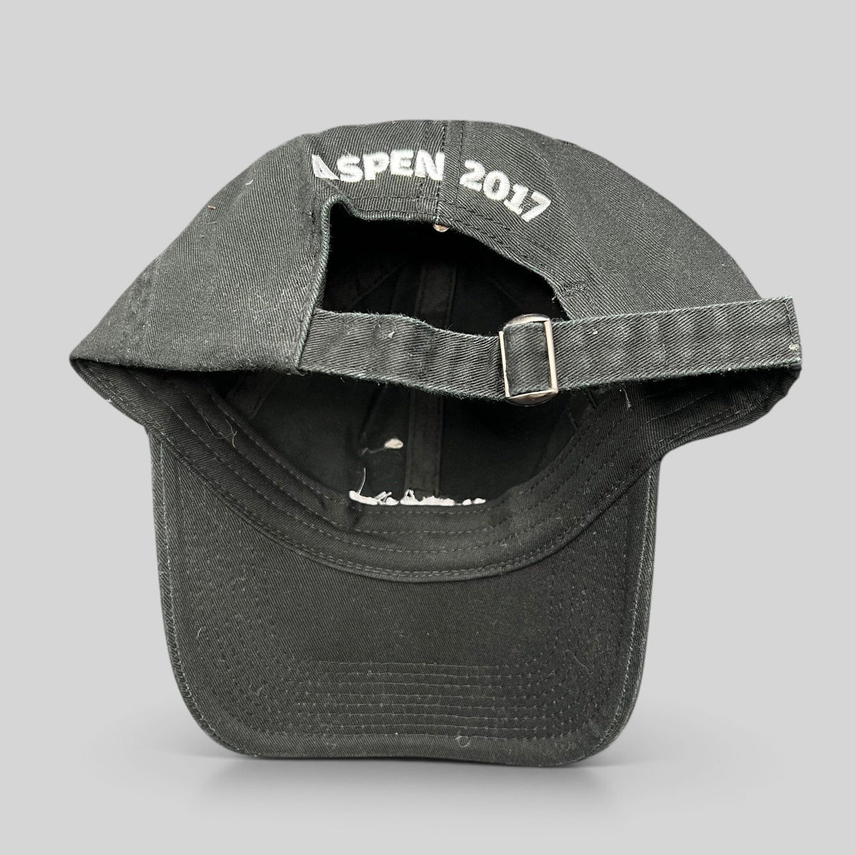 Raree Finds black cotton strapback hat with Aspen 2017 embroidery on the back and adjustable metal buckle closure