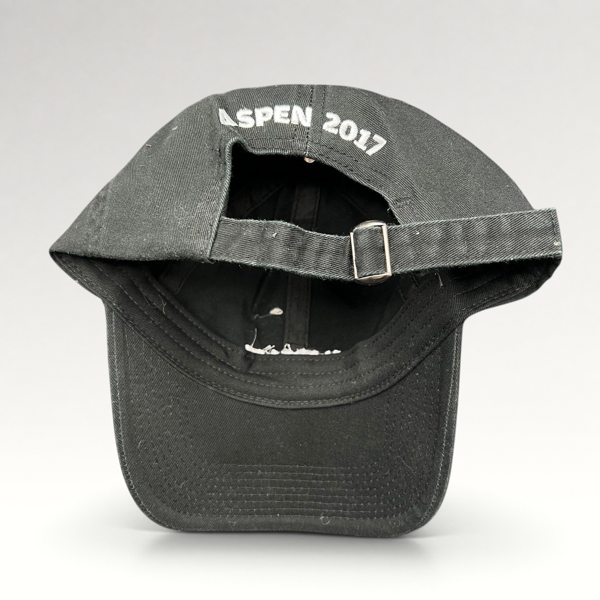 Raree Finds black cotton strapback hat with Aspen 2017 embroidery on the back and adjustable metal buckle closure