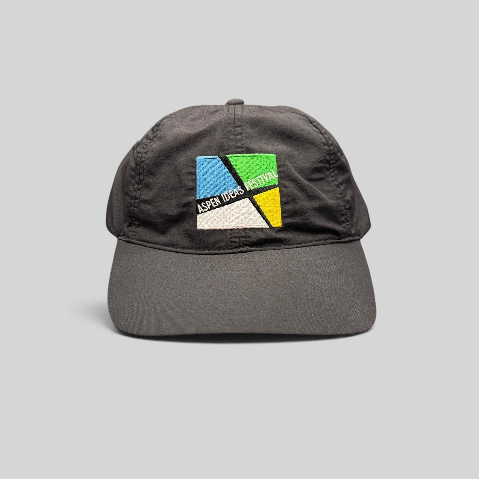 Raree Finds black unstructured strapback hat with embroidered Aspen Ideas Festival logo on the front panel.