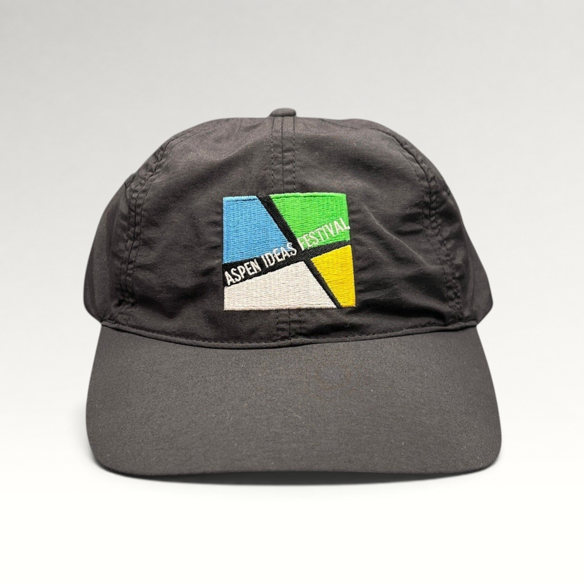 Raree Finds black unstructured strapback hat with embroidered Aspen Ideas Festival logo on the front panel.