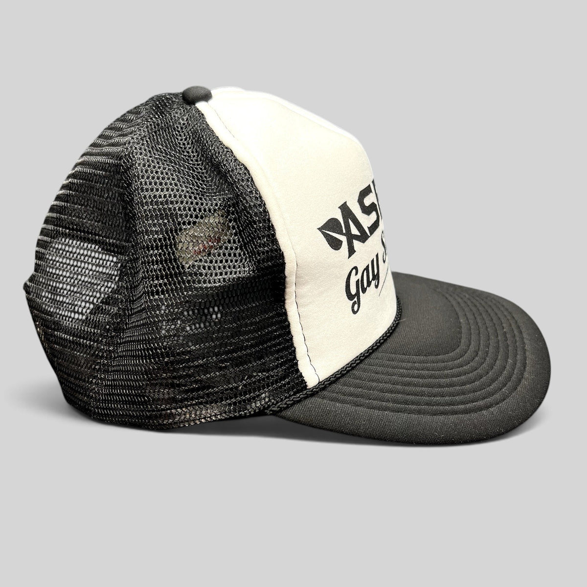 Raree Finds vintage Aspen Gay Ski Week trucker hat with white foam front, black mesh back, and black brim.