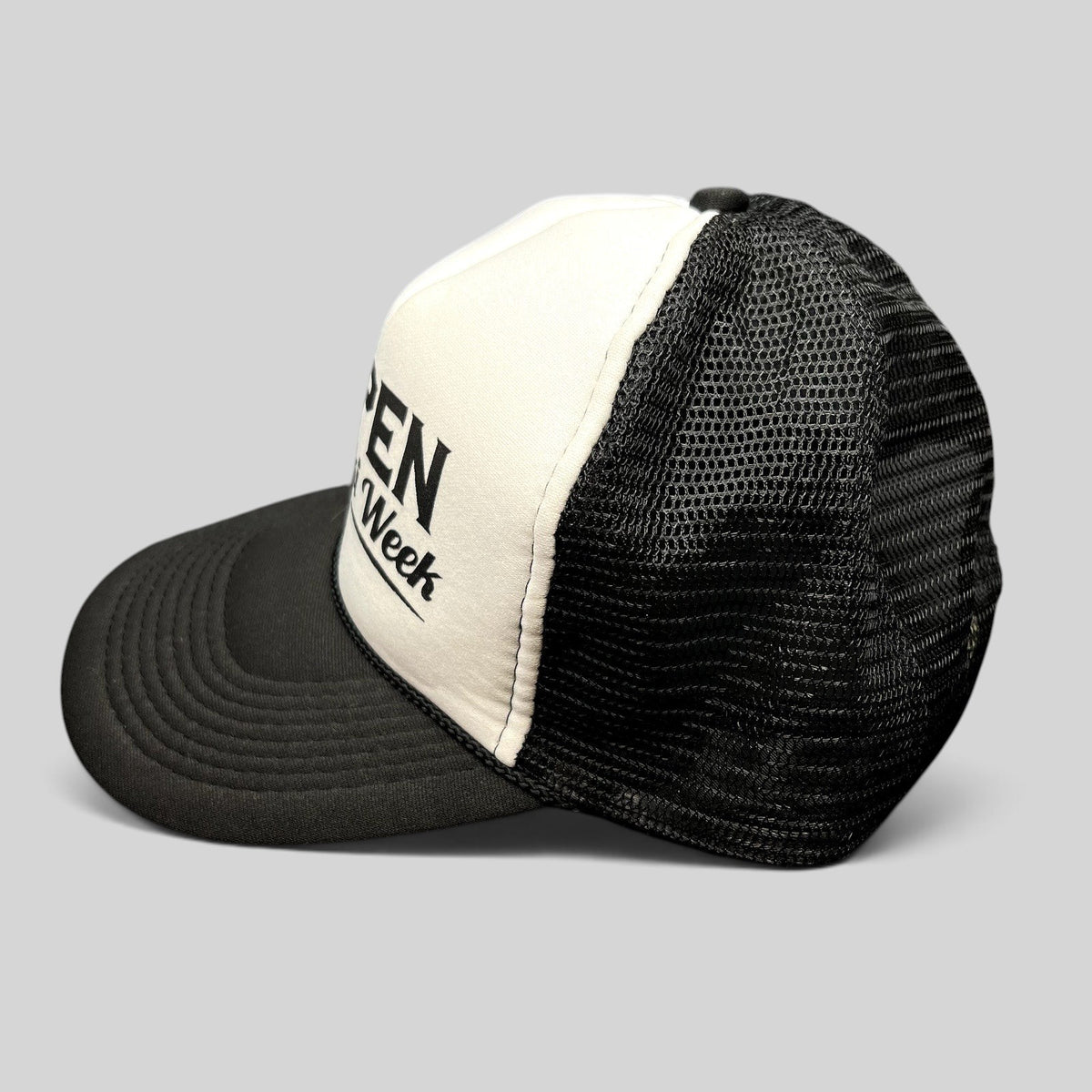 Raree Finds vintage Otto trucker hat in black and white with Aspen Gay Ski Week script on a foam front and mesh back.