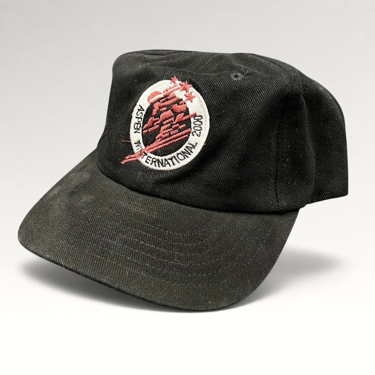Raree Finds vintage black cotton strapback hat with Aspen Winternational 2000 skier embroidery and Chevy branding.