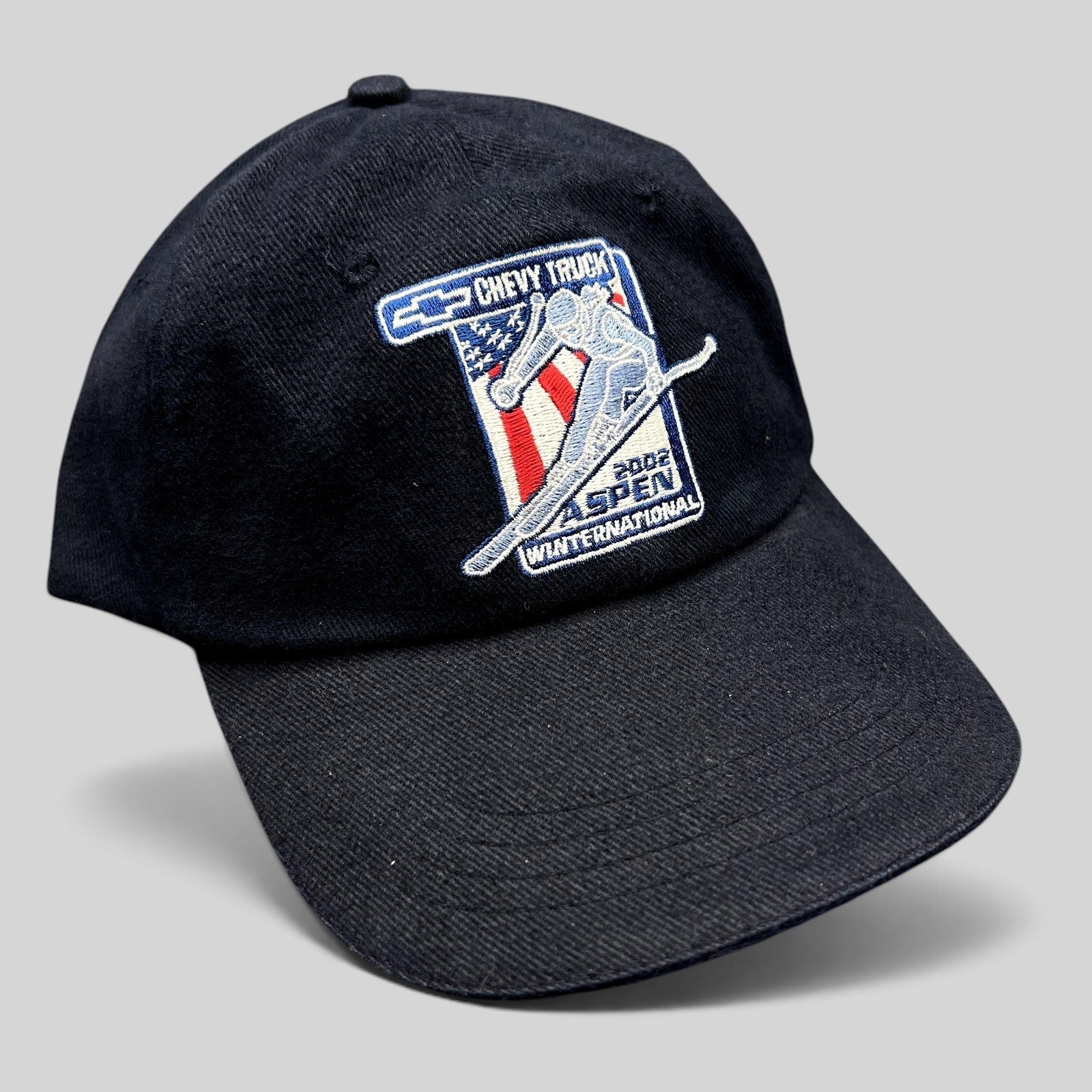 Raree Finds navy blue 2002 Aspen Winternational cotton strapback hat with Chevrolet Truck and skier embroidery.