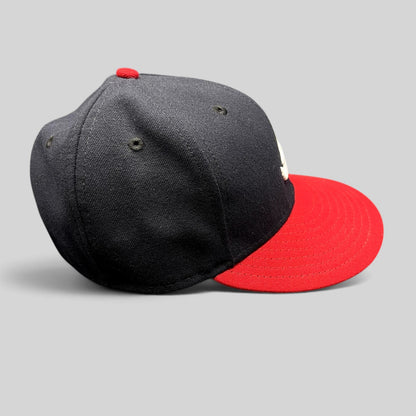 Raree Finds Atlanta Braves 59FIFTY fitted hat with navy crown, red visor, and embroidered logo on a grey background.