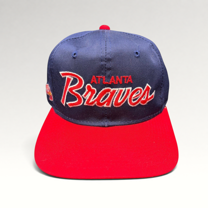 Raree Finds vintage 90s Atlanta Braves Sports Specialties snapback hat with navy crown, red brim, and script logo.