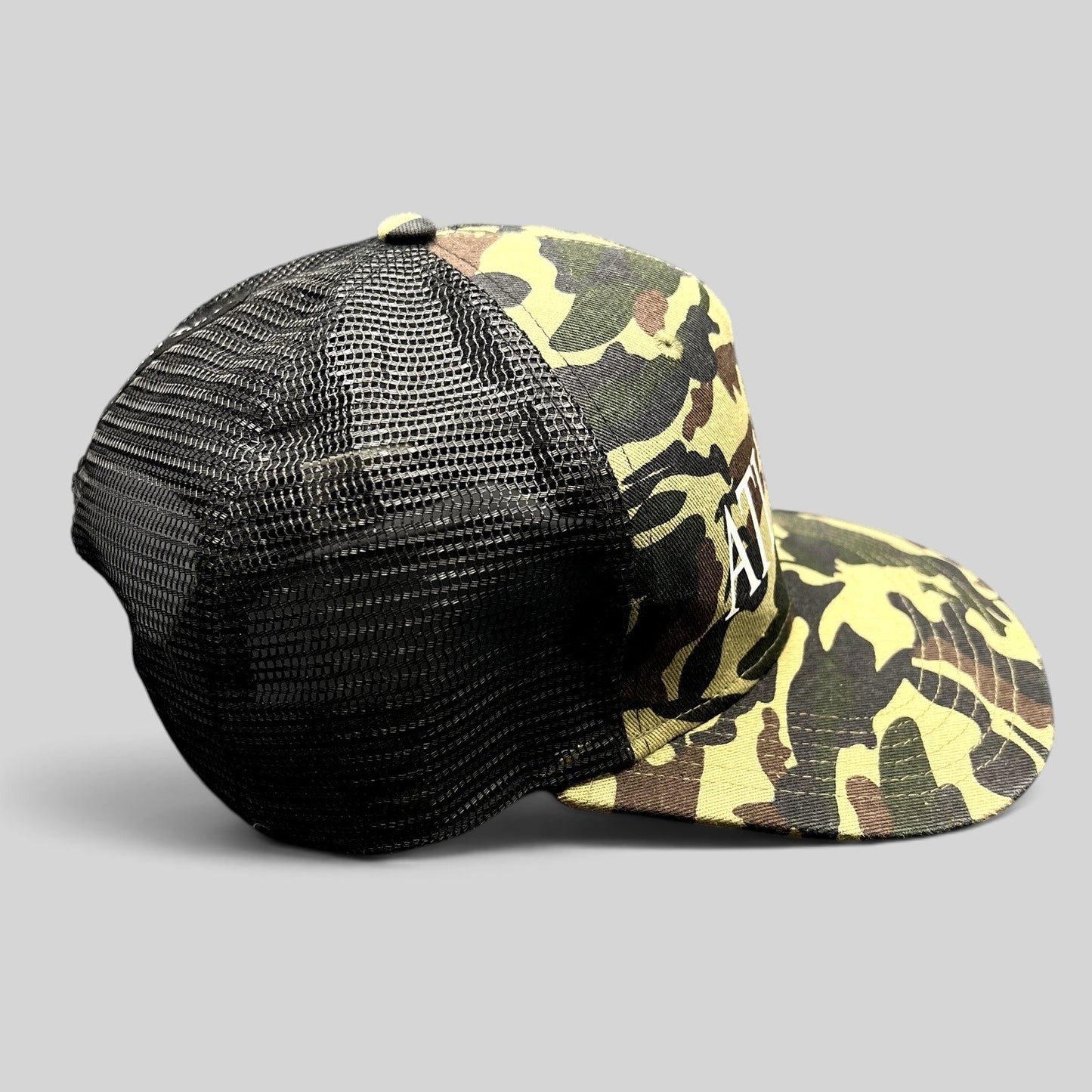 Raree Finds ATLWOOD woodland camo mesh trucker snapback hat with white front embroidery and black rear mesh panels.