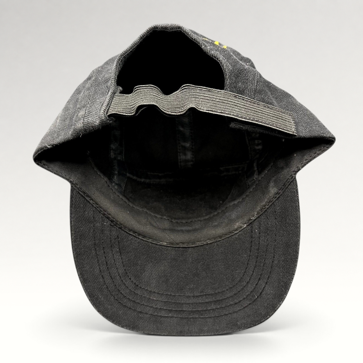 Raree Finds vintage black cotton Atomic ARC ski cap showing the interior elastic strapback and brim construction