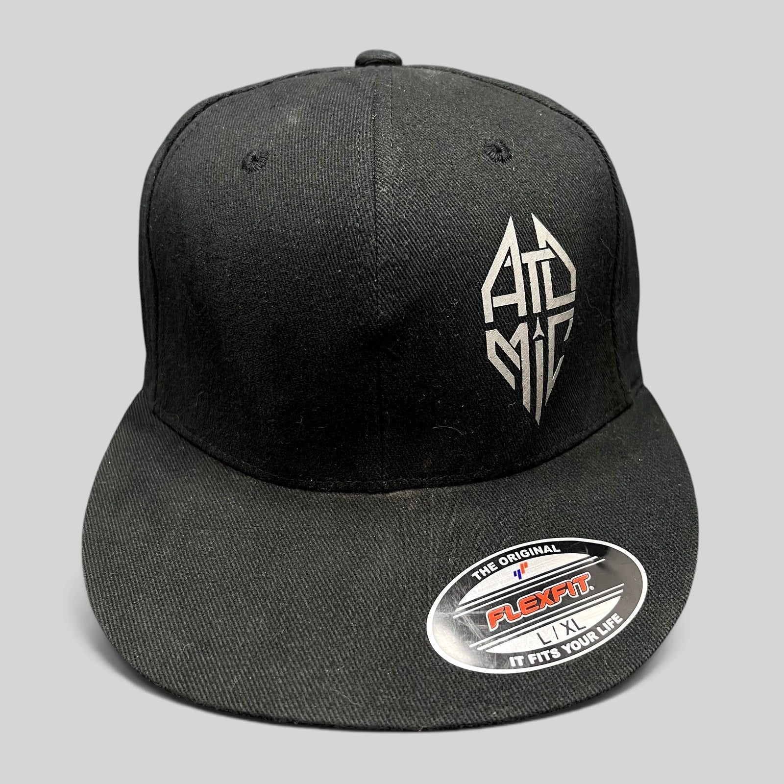 Raree Finds black Atomic Skis FlexFit cap with white embroidered logo on the front and a flat brim design.
