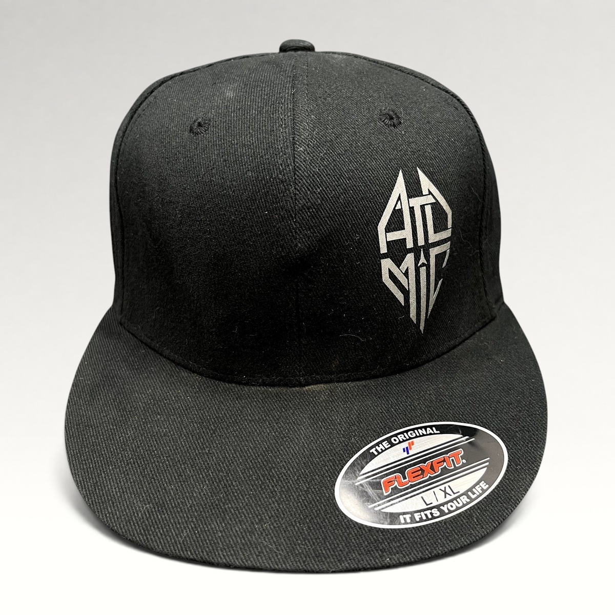 Raree Finds black Atomic Skis FlexFit cap with white embroidered logo and flat brim, size L/XL.