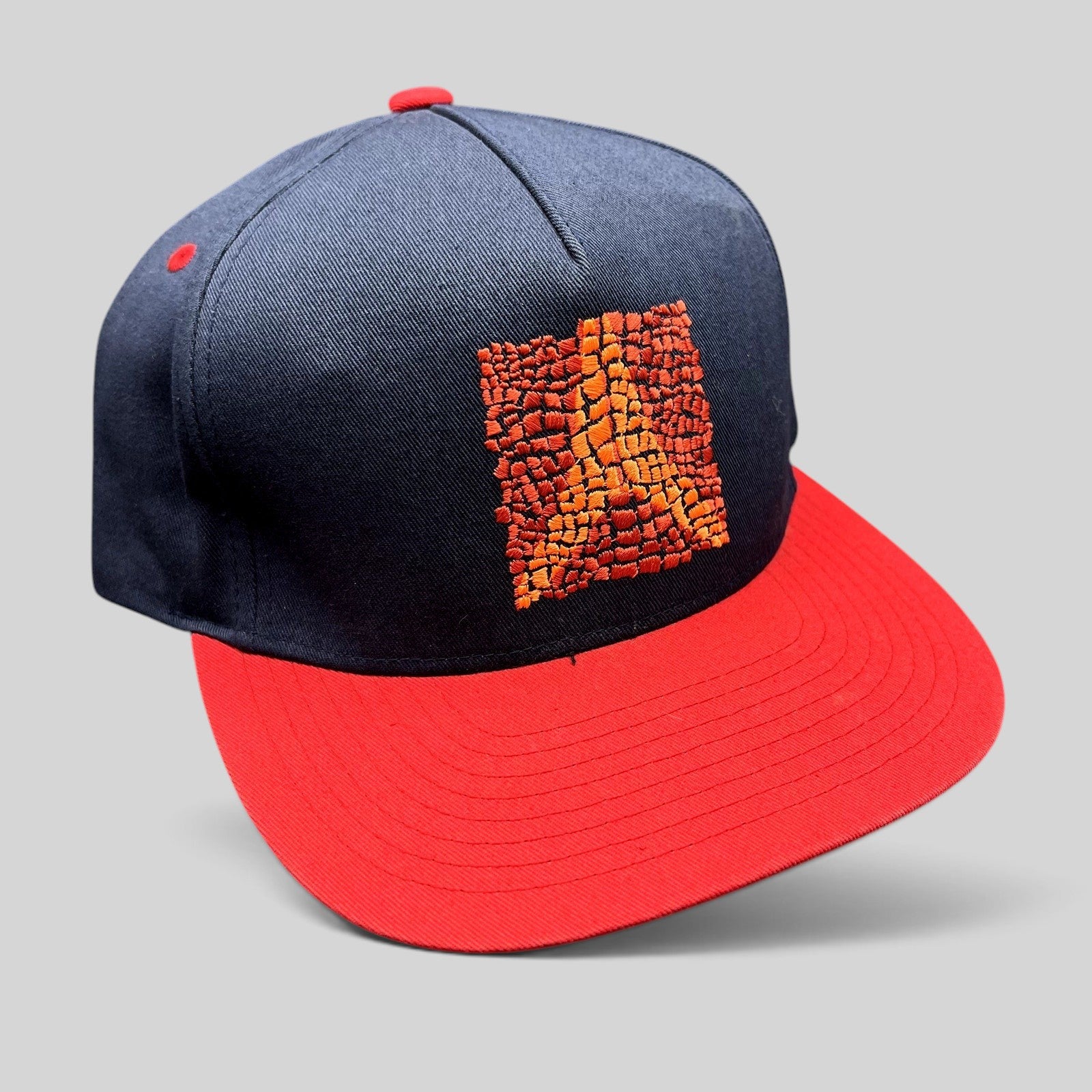 Raree Finds Atomic Skis navy and red snapback hat with embroidered Eiffel Tower mosaic graphic on the front